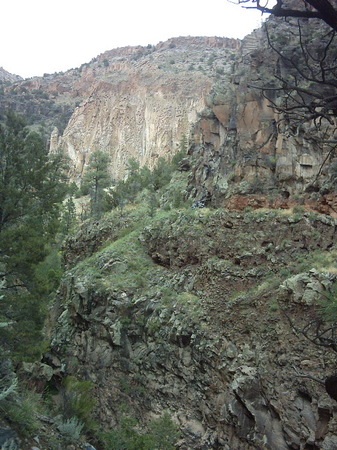 The weathered tuff cliffs behind the stronger volcanic cliffs