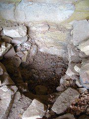 A looted grave in one of the rooms, probably a child's grave