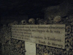 Memorial inscription in front of another of the ubiquitous walls of bones.
